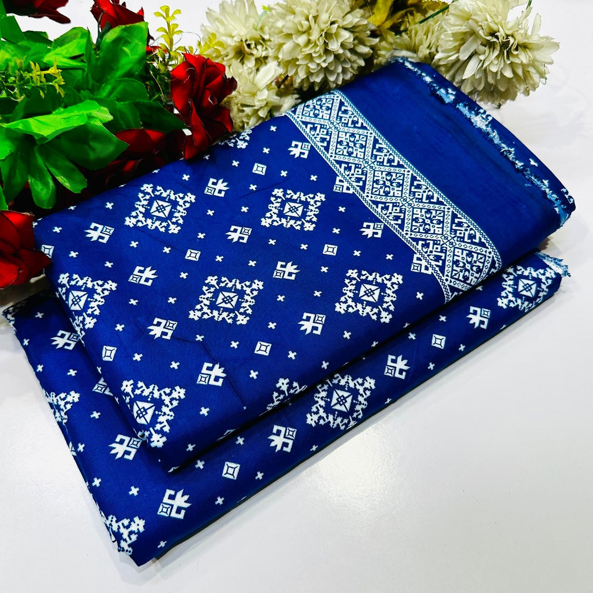 2 piece suit in blue  with a white geometric and floral pattern
